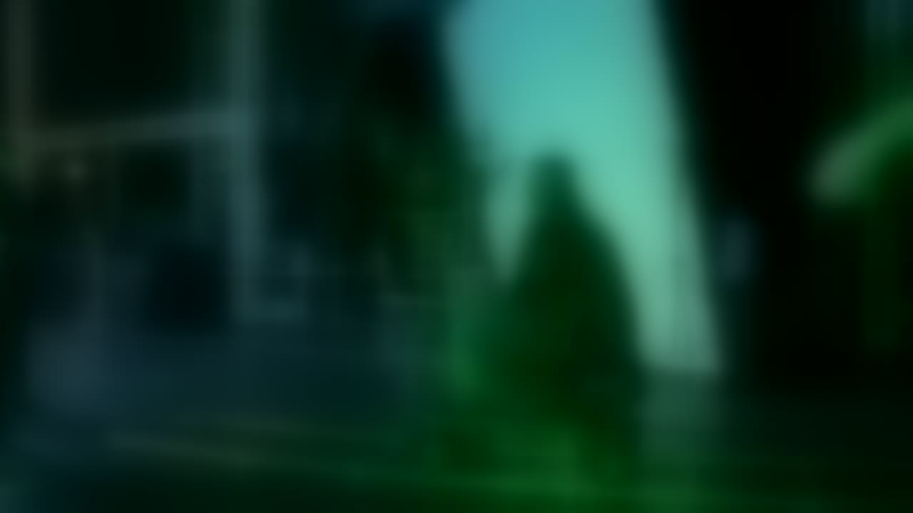 Blurred on-set still from the feature film R&D test: a camera operator on a dolly, lit green against a diffusion frame